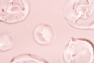Transparent hyaluronic acid gel on a pink background.