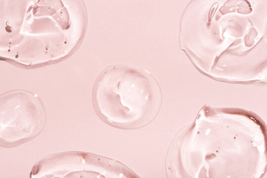 Transparent hyaluronic acid gel on a pink background.
