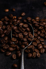 Roasted coffee beans close-up on a dark background. Colombian coffee