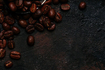 Roasted coffee beans close-up on a dark background. Colombian coffee