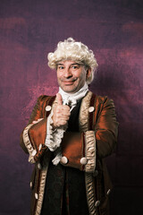 Adult man in classical medieval clothing showing thumb up while standing on an isolated background.