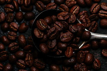 Roasted coffee beans close-up on a dark background. Colombian coffee