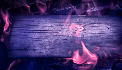 Burning deep violet horizontal board with open purple fire flame. Violet burned wooden board...