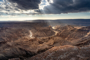 Fototapeta na wymiar wonderful view over the fish river canyon at sunset with amazing clouds and golden light