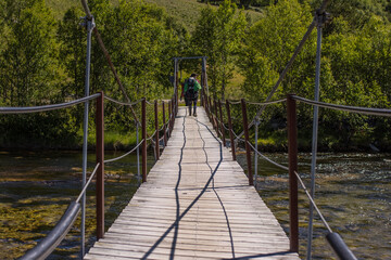 Footbridge across the river in Rondane National Park in Norway - the oldest national park in Norway with 10 peaks above  2,000 metres.