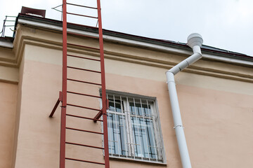 Metal ladder to the roof of the house.