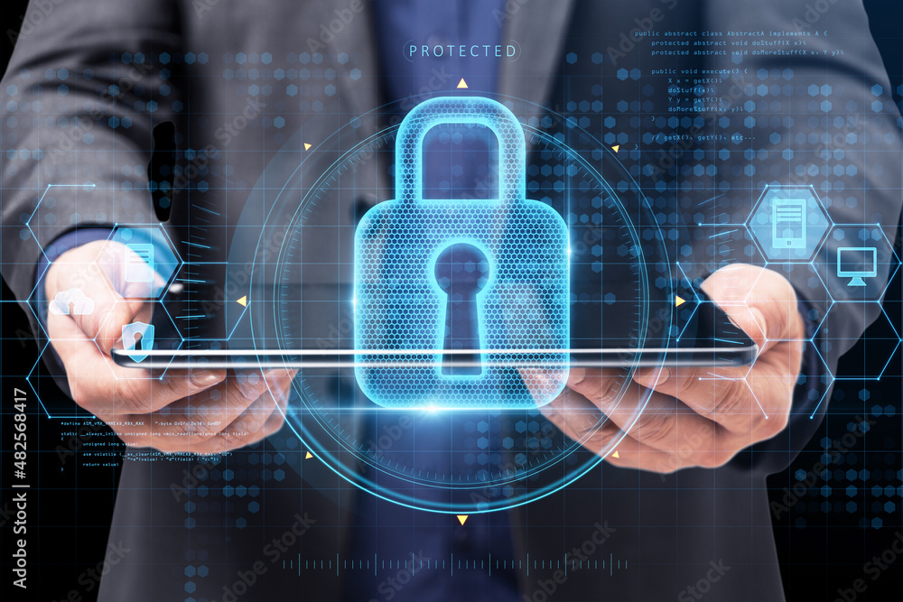 Poster close up of businessman hand holding tablet with abstract glowing keyhole padlock interface on blurr