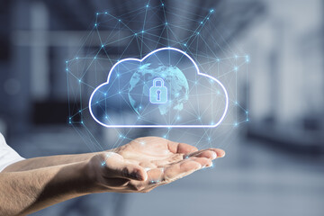 Close up of business man hand holding abstract glowing cloud hologram with globe and safety icons, polygonal mesh on blurry interior background. 