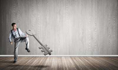 Breaking through access concept with man in room crashing concrete key