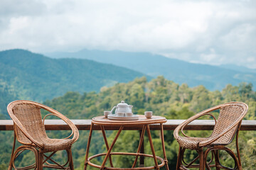 teapot set on table in the morning with mountain view at countryside home or homestay. Vacation,...