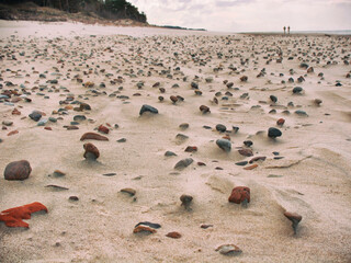 Close up of sandy beach with stones