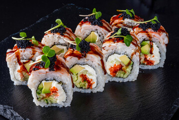 Set fresh delicious Japanese sushi on dark background