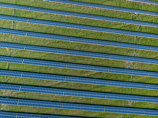 Reduce electricity consumption by using solar panels standing in a row next to each other in the field.