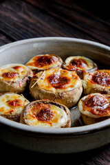 Stuffed mushroom caps with cheese and other stuffing, stuffed mushrooms. Georgian cuisine concept, traditional dish.