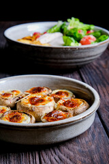 Stuffed mushroom caps with cheese and other stuffing, stuffed mushrooms. Georgian cuisine concept, traditional dish.