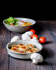 Stuffed mushroom caps with cheese and other stuffing, stuffed mushrooms. Georgian cuisine concept, traditional dish.