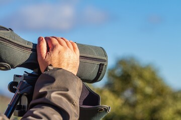 Unrecognizable man's hand observing nature with a telescope in the Sierra de Andújar, Jaén...