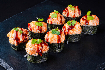 Set fresh delicious Japanese sushi on dark background