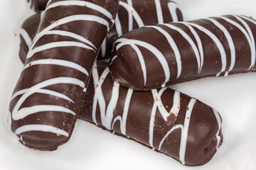 Cookies with striped dark and white chocolate glaze close-up