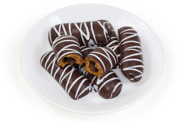 Cookies with striped chocolate glaze and jam filling on dish