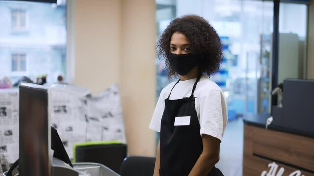 Portrait Of An African American Worker At Grocery Store Checkout, Wearing Mask