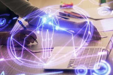 Double exposure of woman hands typing on computer and general theme hologram drawing. Education concept.