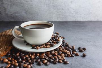 Coffee cup and coffee beans on table