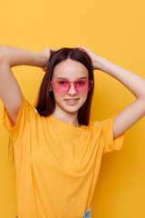 young woman in a yellow t-shirt emotions summer style isolated background