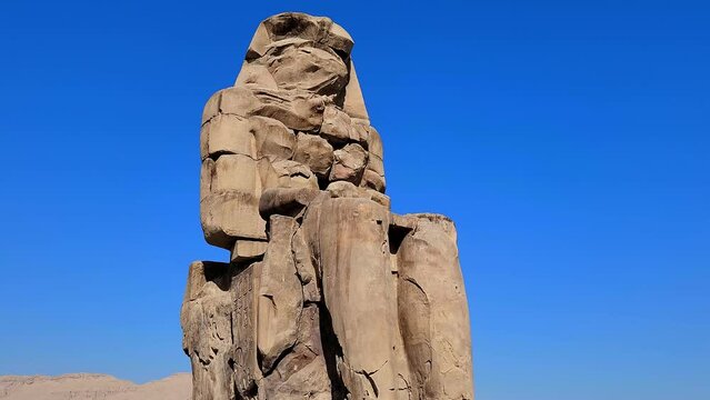 The Colossi of Memnon, two stone massive statues of the Pharaoh Amenhotep III, who reigned in Egypt during the Dynasty XVIII.