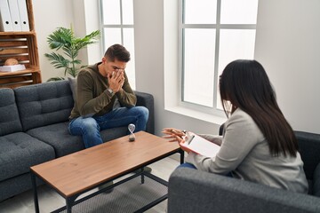 Man and woman having psychology session at clinic