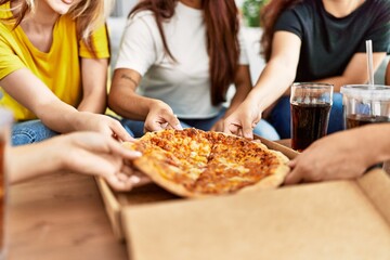 Group of woman holding portion of pizza at home.