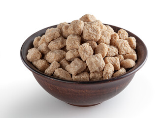 Cubes of brow cane sugar in ceramic bowl isolated on white background with clipping path