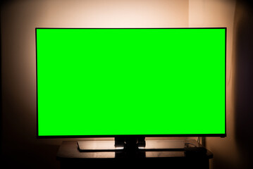green screen tv in a dark room. Watching movies and TV series. online services.