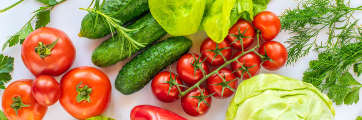 background of fresh products from the garden tomatoes, cucumbers, greens, lettuce, cabbage, dill, basil on a white background. eco vegetables.
