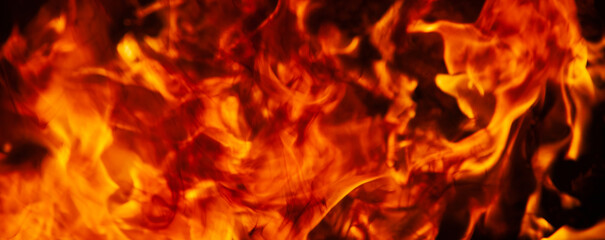 Close up abstract image of fire flames on dark background. Free copy space for design.