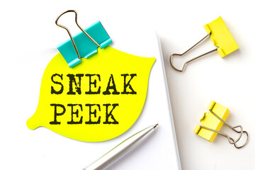 Sticker with SNEAK PEEK text on notebooks on the white background