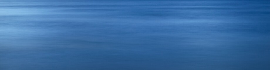 Sea water surface texture. Soft sunlight. Panoramic image, graphic resources. Nature, environment concepts. Long exposure