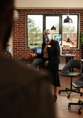 Close up of psychotherapist woman helping people at group therapy session, standing in office to...