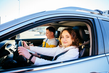 A student driver with her driving instructor