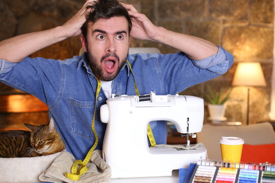 Stressed out man while using sewing machine