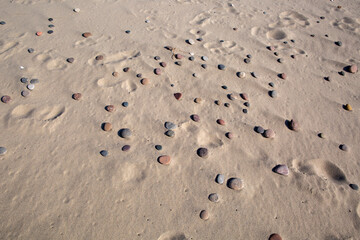 stack of stones on beach with sun light