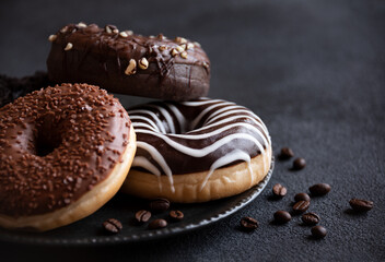 Chocolate donuts and coffee beans, sweet delicious baked dessert - obrazy, fototapety, plakaty