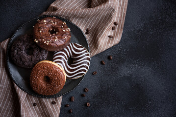 Chocolate donuts and coffee beans, sweet delicious baked dessert