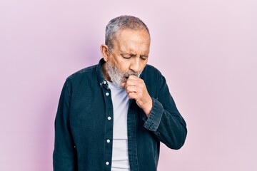 Handsome senior man with beard wearing casual denim shirt feeling unwell and coughing as symptom...