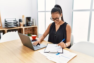 Young latin woman smiling confident working at office