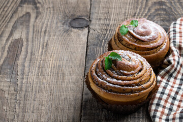 Buns with poppy seeds on wooden table