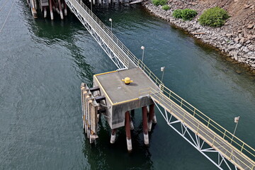 View of the pier and footbridge with lanterns in the evening and at night. Port of Vancouver, WA, USA. August,2020.