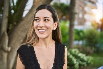 Young hispanic woman smiling confident at park
