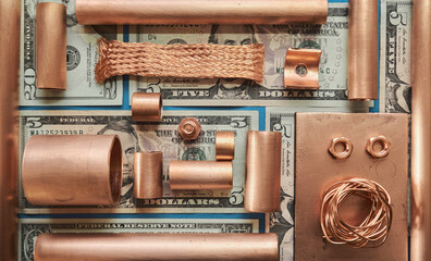 Pieces of copper metal lying on US dollar bank notes.