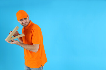Thief delivery man with pizza on blue background